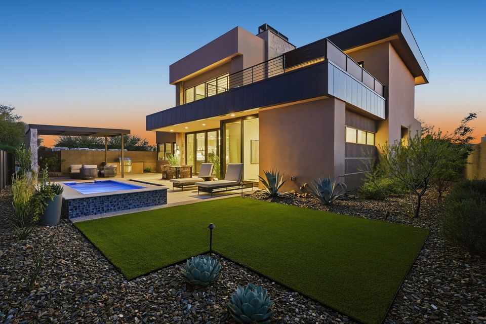 Modern home twilight exterior with pool